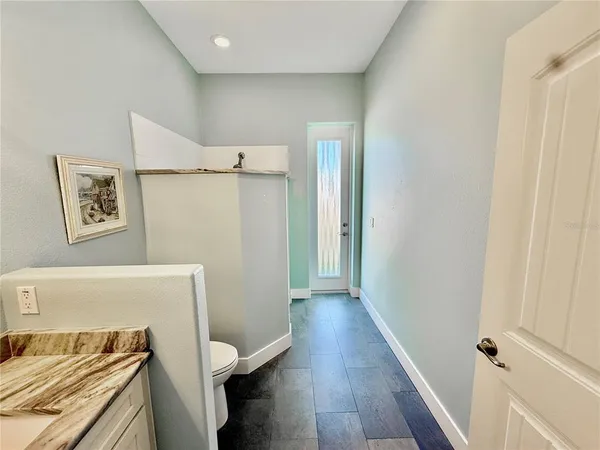 a kitchen with stainless steel appliances granite countertop a sink a refrigerator and a stove