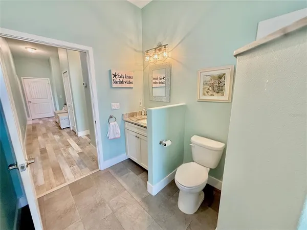 a kitchen with granite countertop cabinets stainless steel appliances and wooden floor