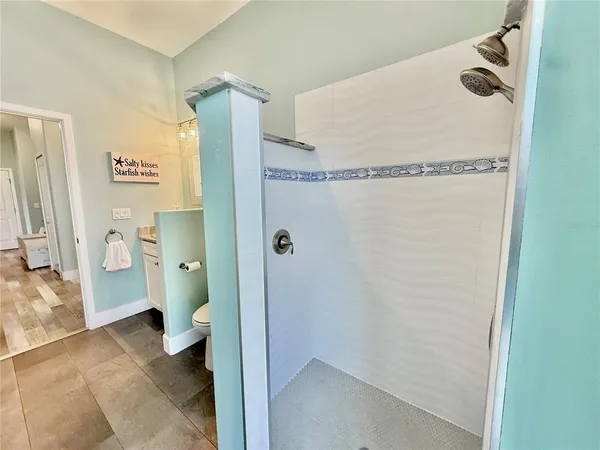 a bathroom with a granite countertop double vanity sink and a mirror