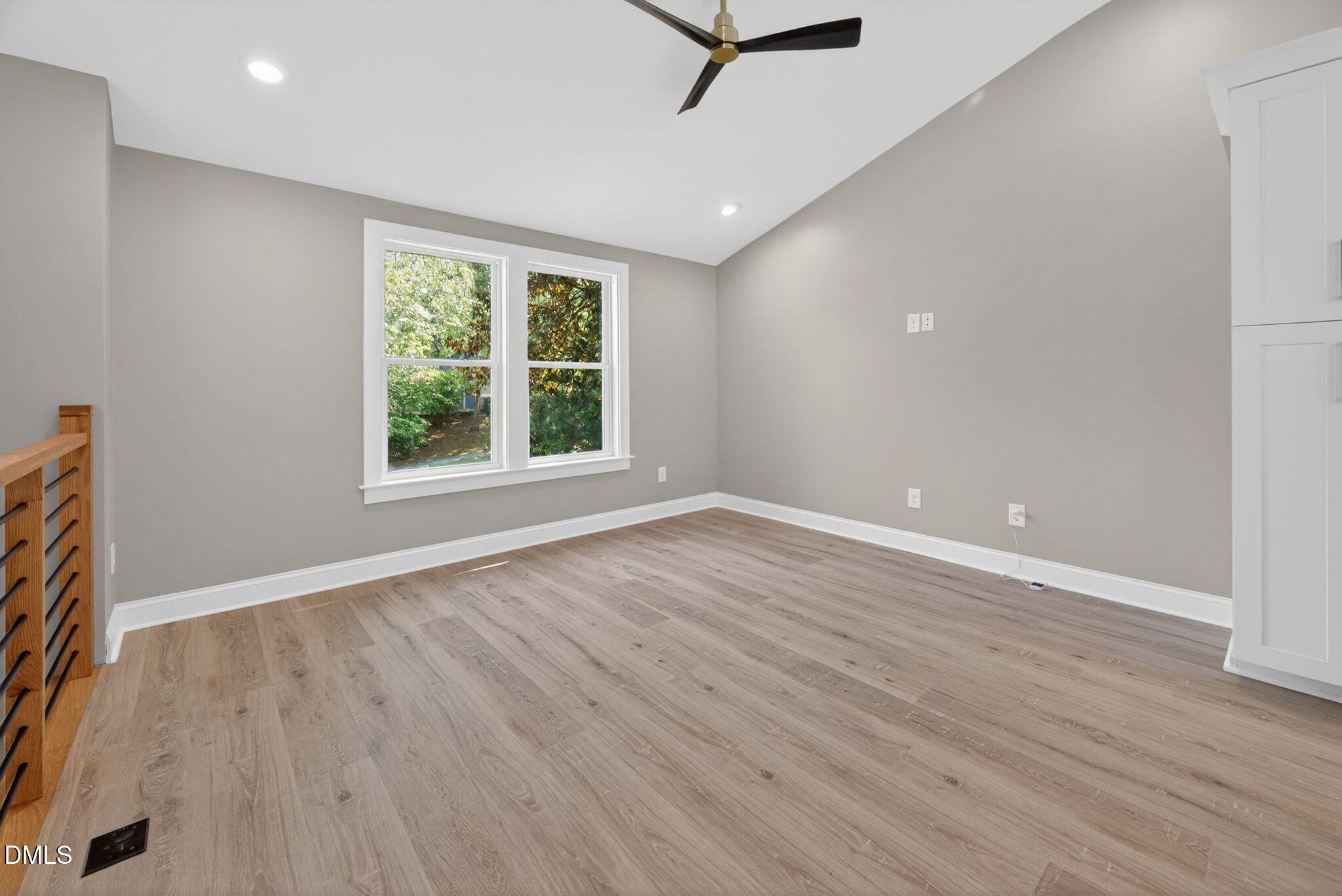 313 Crown Oaks Drive Raleigh, NC 27615 - Photo 45 of 60 an empty room with wooden floor and windows