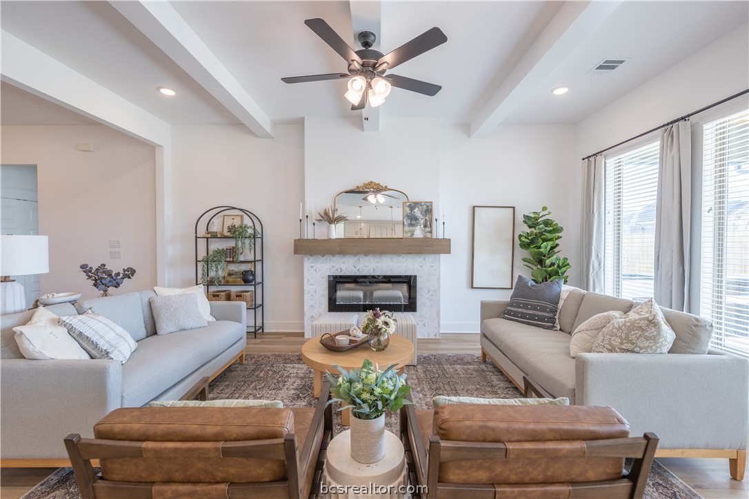 4302 Fox River Lane Bryan, TX 77802 - Photo 1 of 1 a living room with furniture a fireplace and a large window