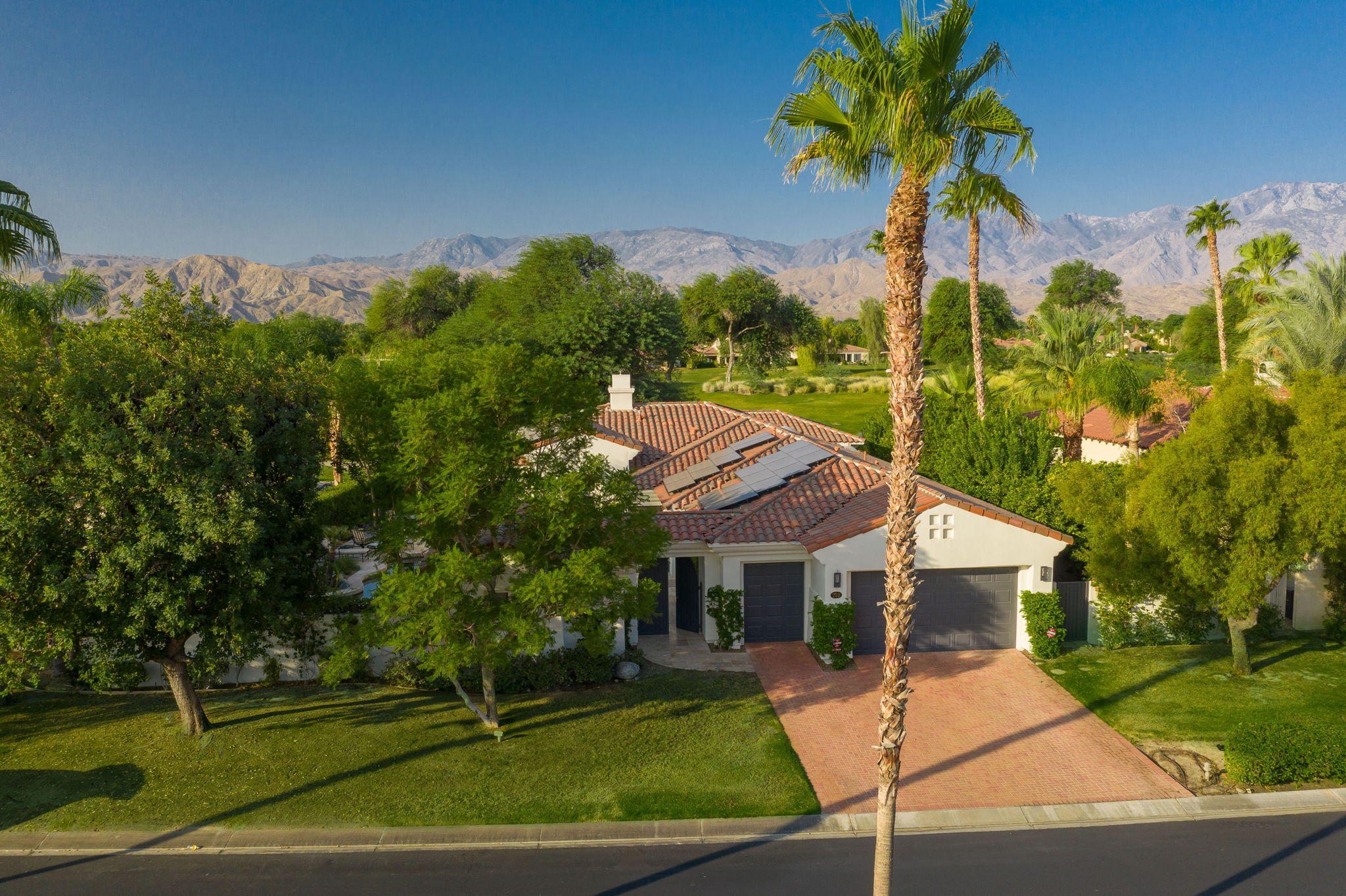 202 Loch Lomond Road Rancho Mirage, CA 92270 - Photo 1 of 47 a front view of a house with garden