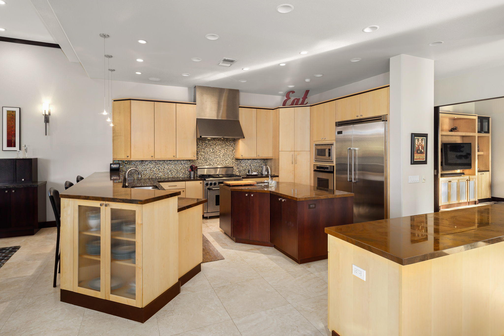 202 Loch Lomond Road Rancho Mirage, CA 92270 - Photo 11 of 47 a kitchen with stainless steel appliances kitchen island granite countertop a refrigerator a stove and a sink with wooden floor