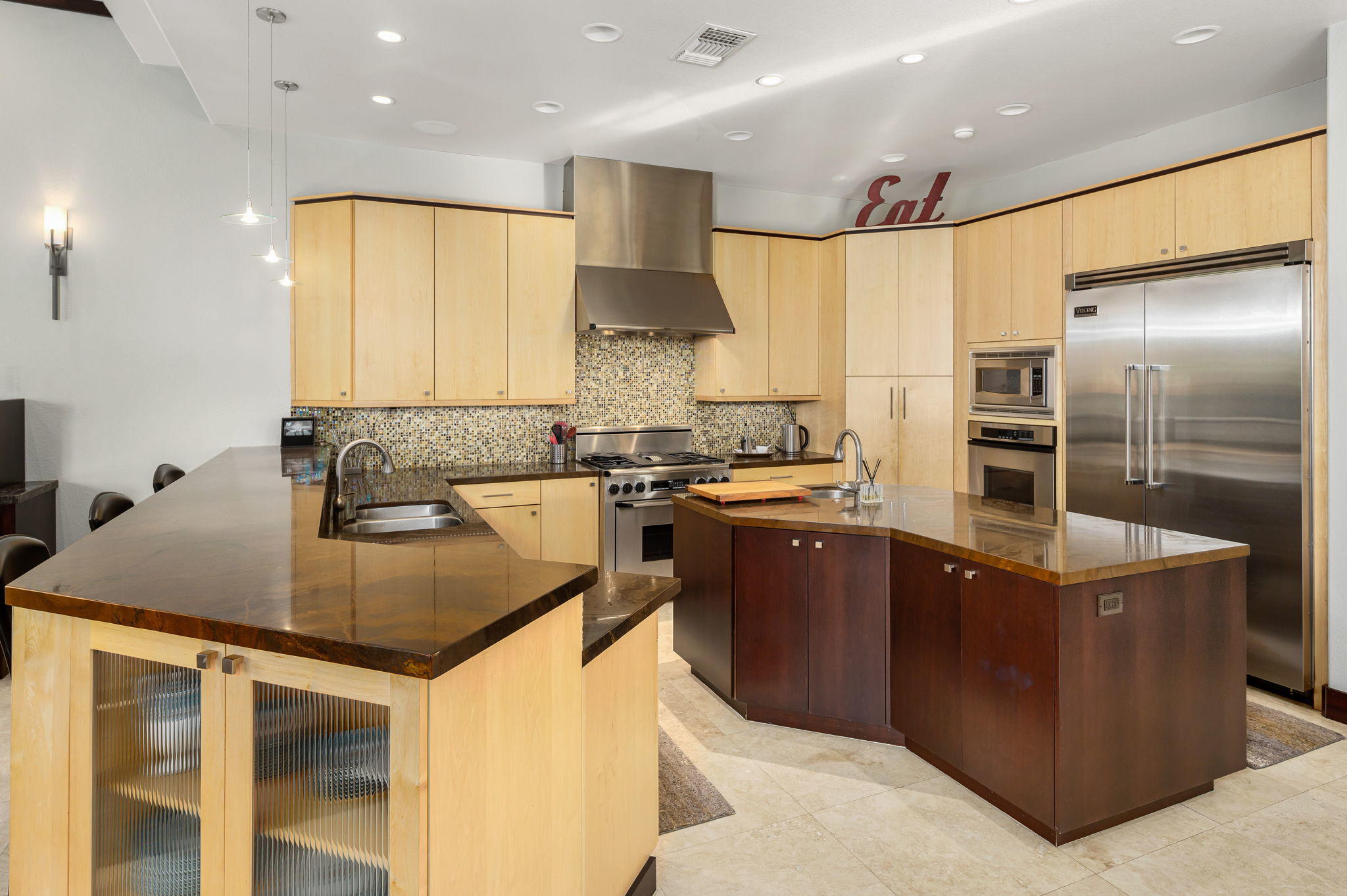 202 Loch Lomond Road Rancho Mirage, CA 92270 - Photo 12 of 47 a kitchen with stainless steel appliances granite countertop a sink counter space and a refrigerator