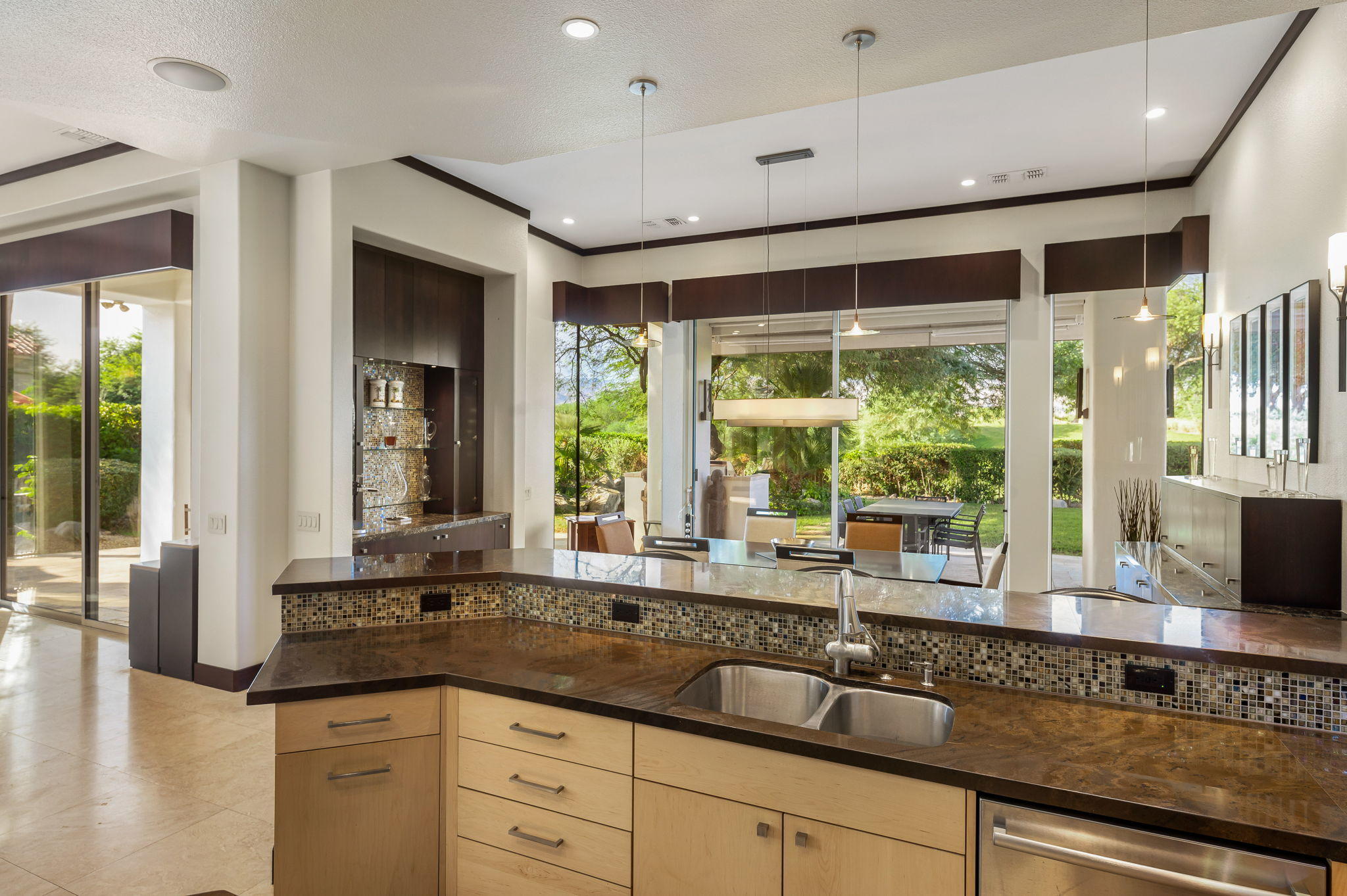 202 Loch Lomond Road Rancho Mirage, CA 92270 - Photo 14 of 47 a kitchen with granite countertop a sink and a large window