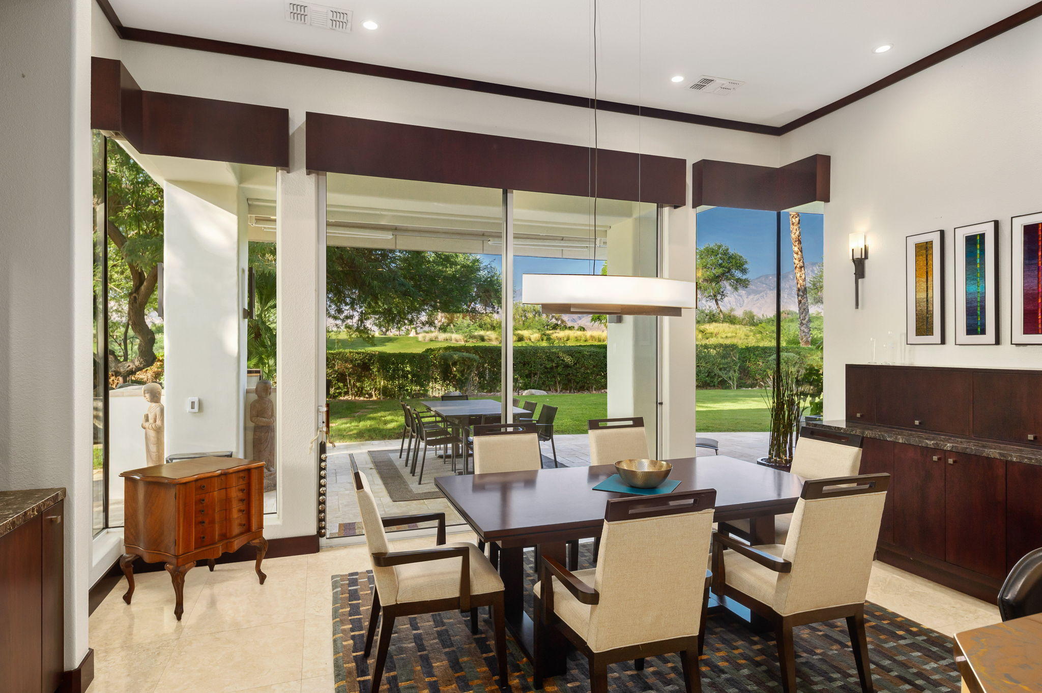 202 Loch Lomond Road Rancho Mirage, CA 92270 - Photo 15 of 47 a view of a dining room with furniture large windows and wooden floor