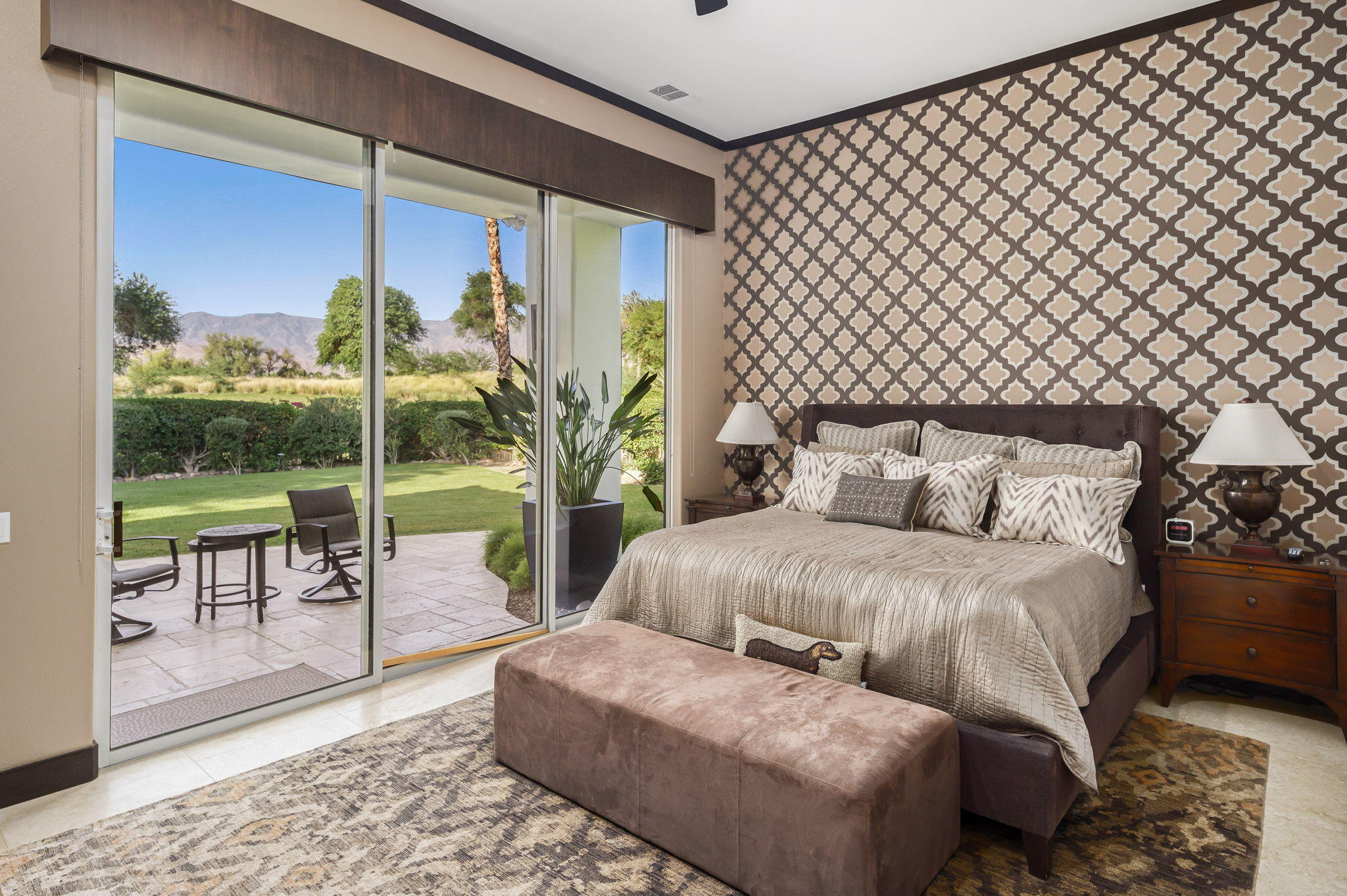 202 Loch Lomond Road Rancho Mirage, CA 92270 - Photo 18 of 47 a spacious bedroom with a balcony a bed and a table
