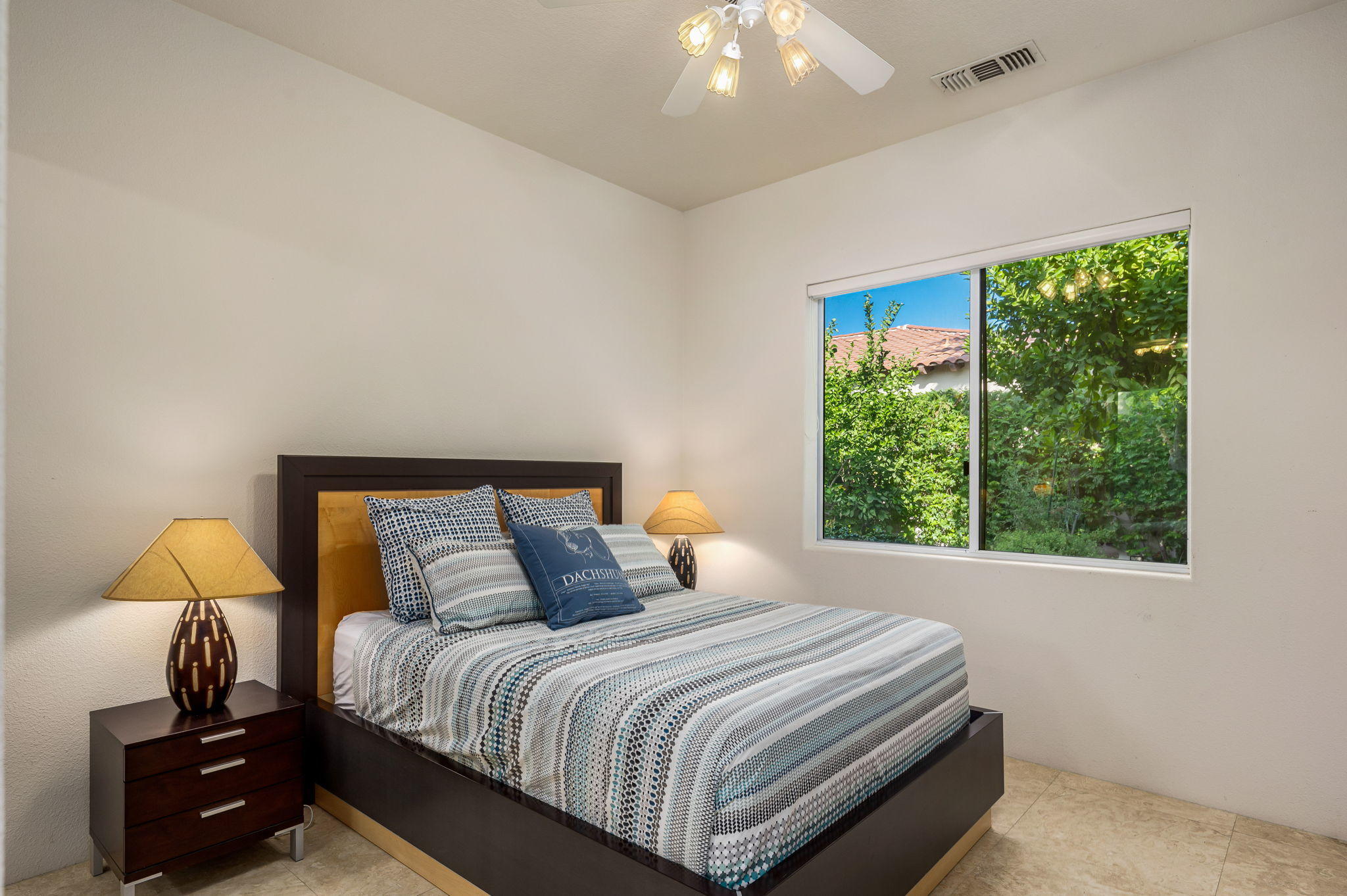 202 Loch Lomond Road Rancho Mirage, CA 92270 - Photo 22 of 47 a bedroom with a bed and a lamp