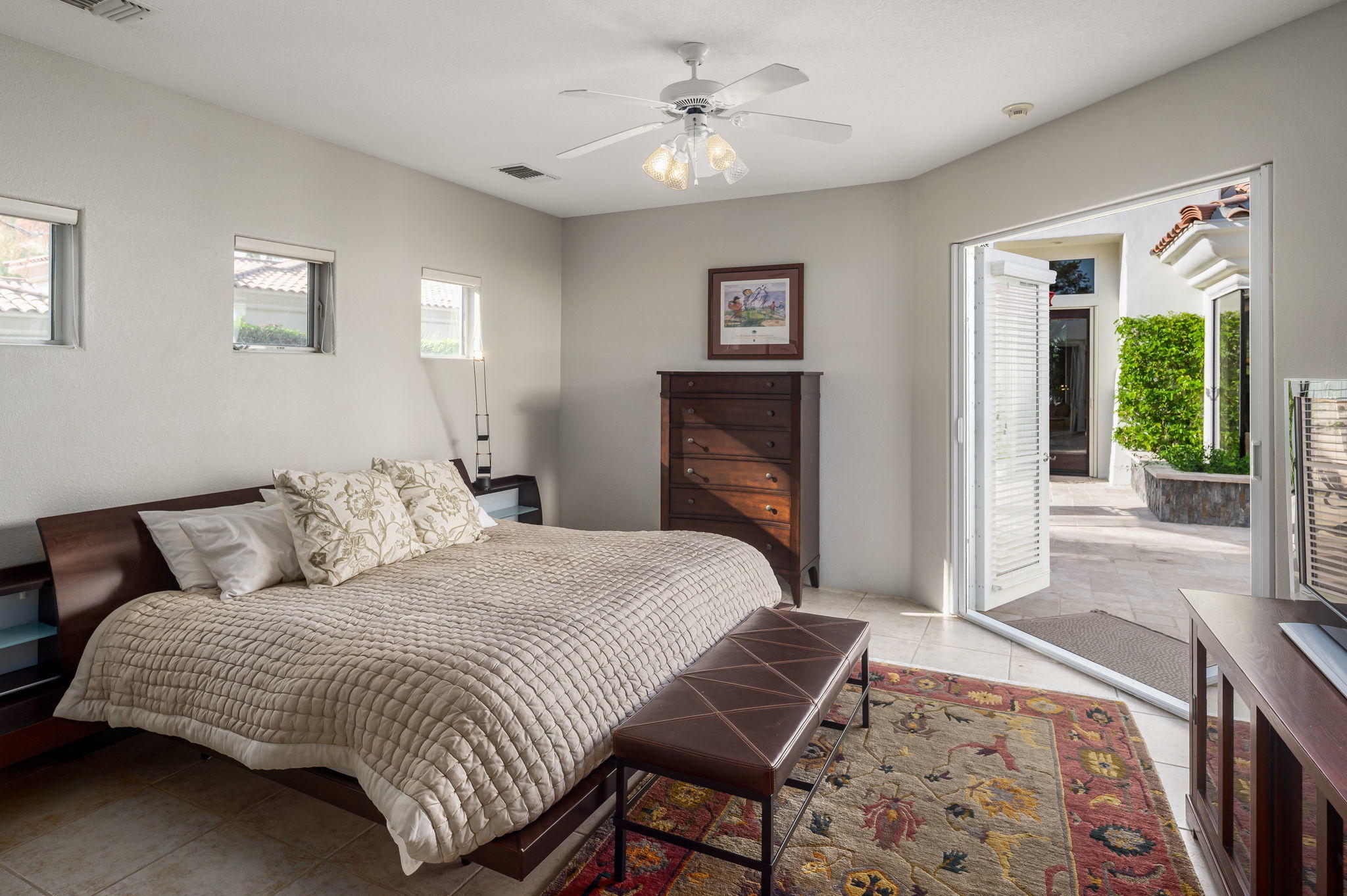 202 Loch Lomond Road Rancho Mirage, CA 92270 - Photo 27 of 47 a bedroom with a large bed and a chandelier
