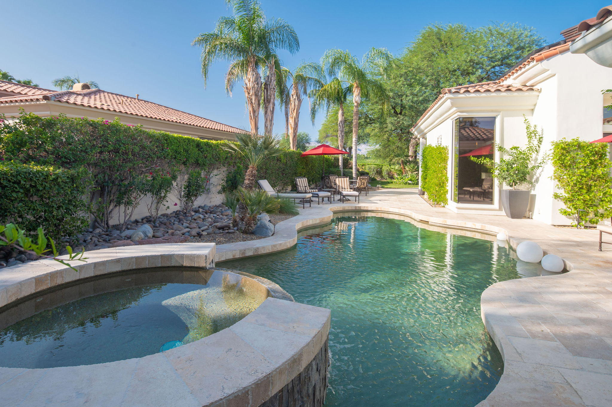 202 Loch Lomond Road Rancho Mirage, CA 92270 - Photo 31 of 47 a view of a swimming pool with a patio