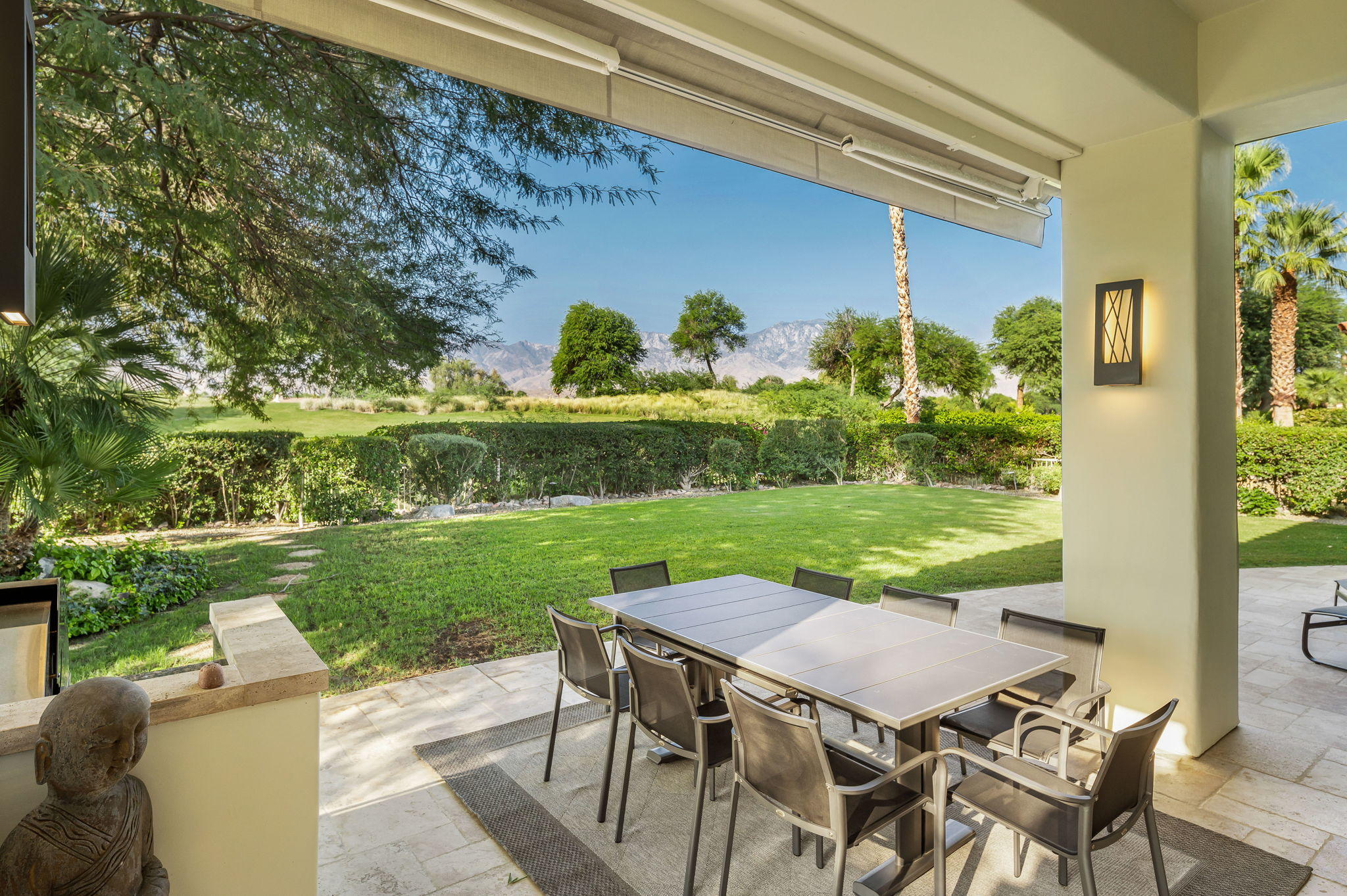 202 Loch Lomond Road Rancho Mirage, CA 92270 - Photo 34 of 47 a view of a patio with table and chairs and potted plants