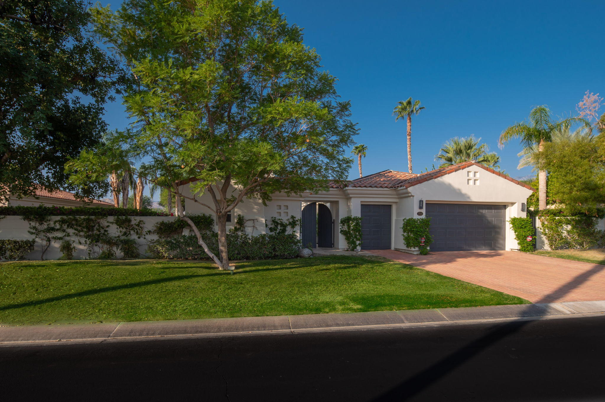 202 Loch Lomond Road Rancho Mirage, CA 92270 - Photo 5 of 47 a front view of a house with a yard and garage