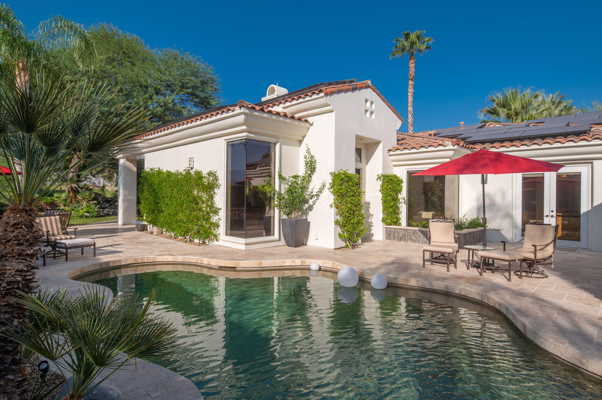 202 Loch Lomond Road Rancho Mirage, CA 92270 - Photo 42 of 47 a house with swimming pool in front of it