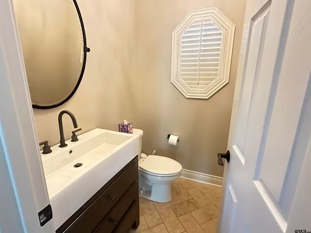 a spacious bedroom with two beds and a chandelier