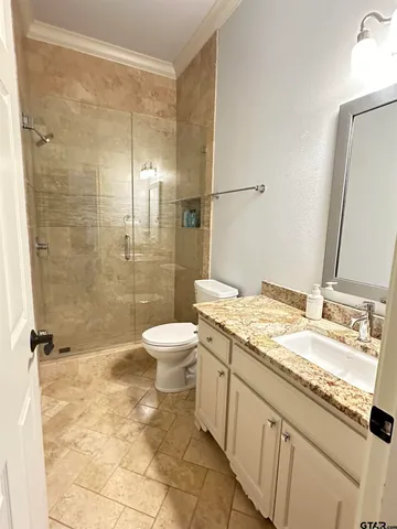 a spacious bedroom with a large bed and a large window