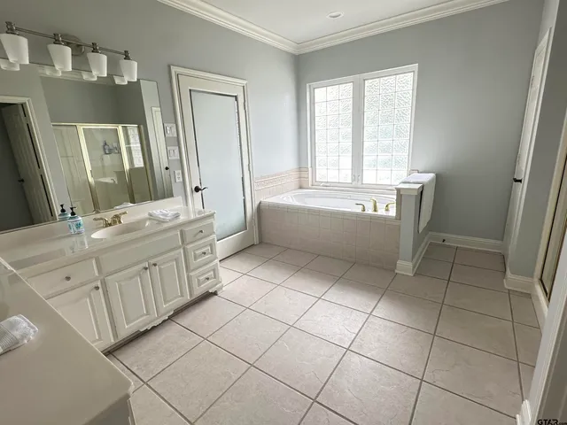 a room with a sink a mirror and cabinets