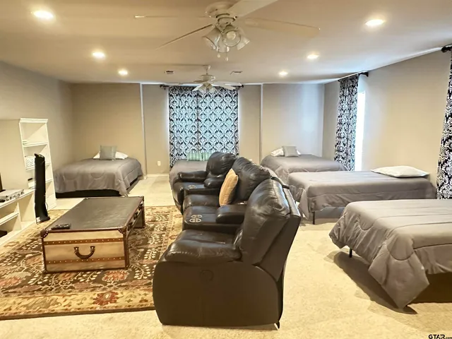 a bathroom with a granite countertop sink and a toilet