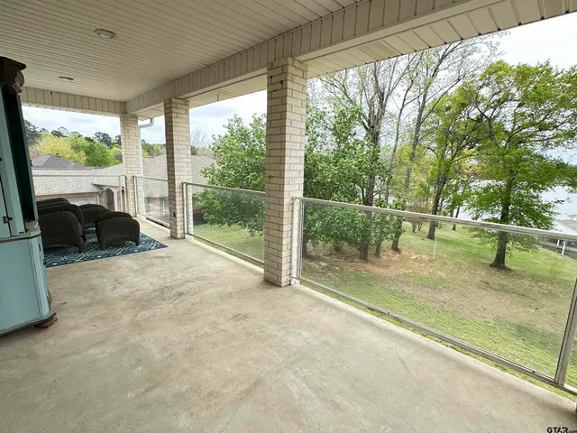 a view of a swimming pool with a lawn chairs under an umbrella