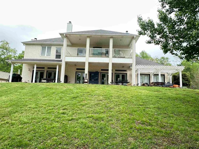 an aerial view of a house with pool yard and outdoor seating
