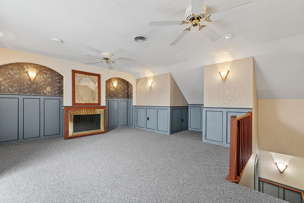8 Deer Path, Unit 5 Maynard, MA 01754 - Photo 12 of 25 an empty room with windows fireplace and a kitchen view