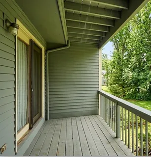 a view of a balcony with wooden floor