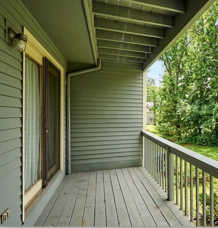 8 Deer Path, Unit 5 Maynard, MA 01754 - Photo 18 of 25 a view of a balcony with wooden floor
