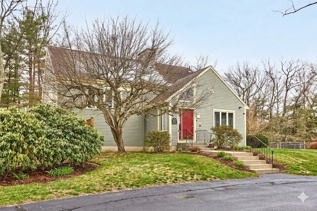 8 Deer Path, Unit 5 Maynard, MA 01754 - Photo 20 of 25 a front view of house with yard and trees around