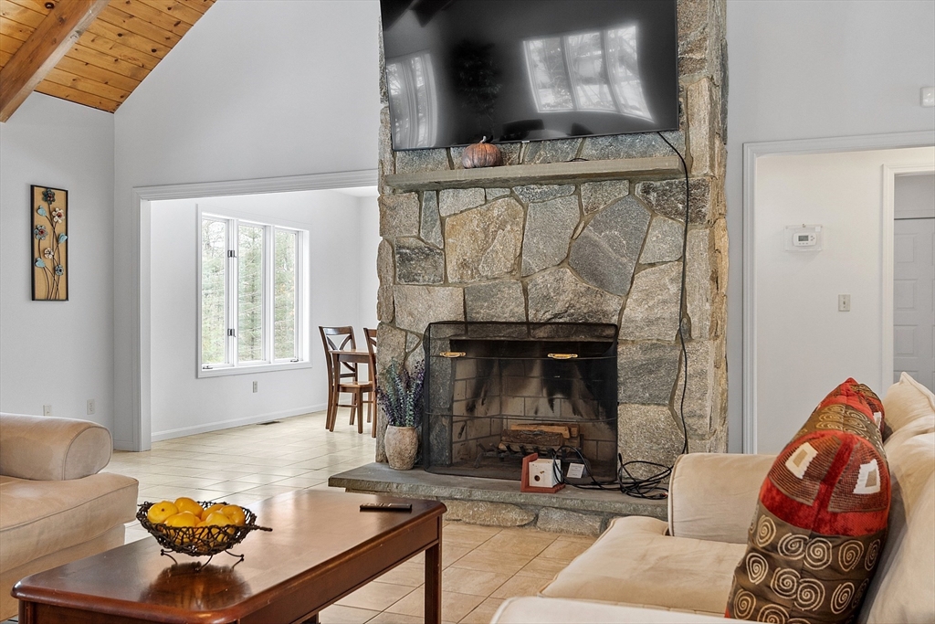 8 Deer Path, Unit 5 Maynard, MA 01754 - Photo 22 of 25 a living room with furniture and a fireplace