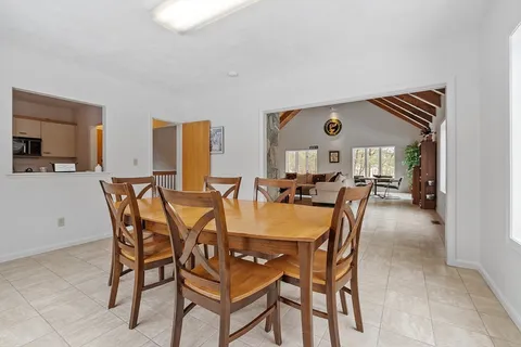 a dining room with furniture and window