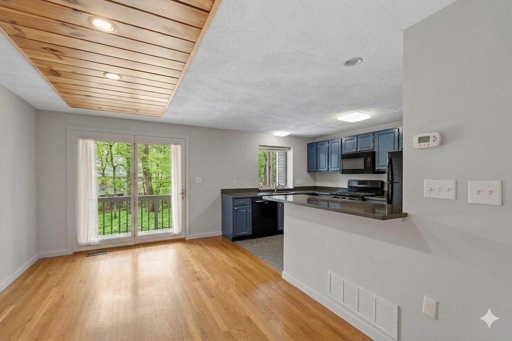 8 Deer Path, Unit 5 Maynard, MA 01754 - Photo 4 of 25 a kitchen with stainless steel appliances a refrigerator sink and stove