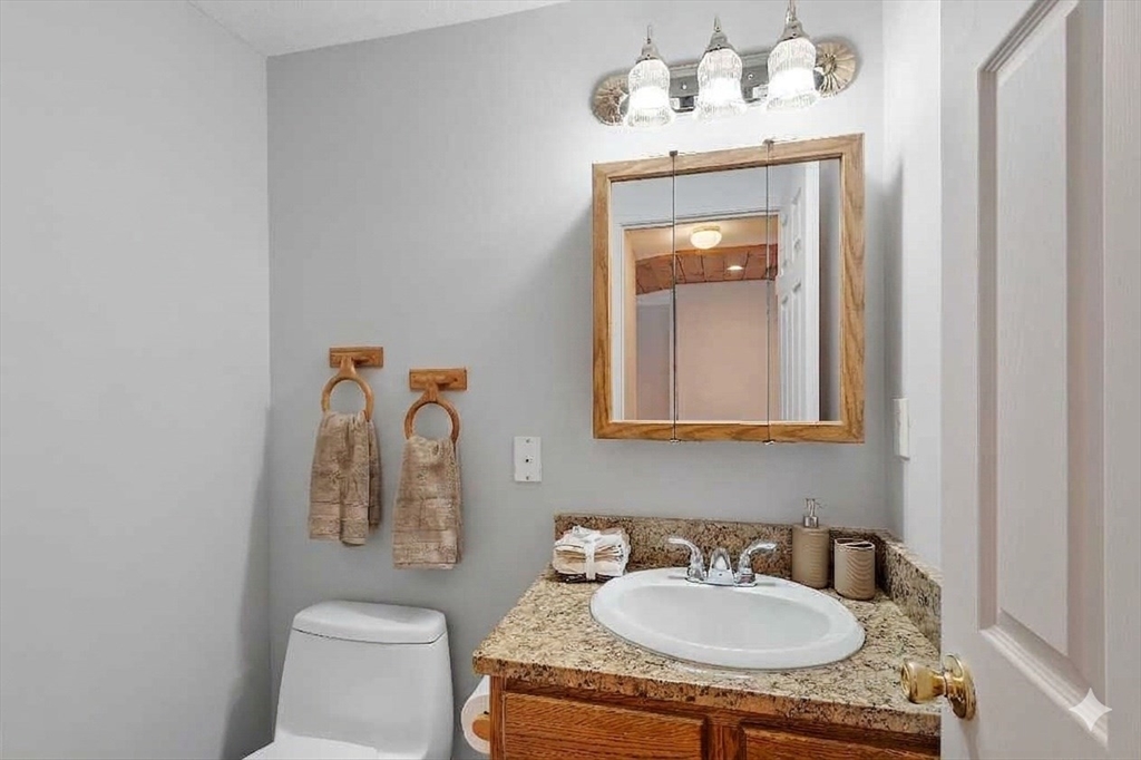 8 Deer Path, Unit 5 Maynard, MA 01754 - Photo 6 of 25 a bathroom with a sink and a mirror with toilet