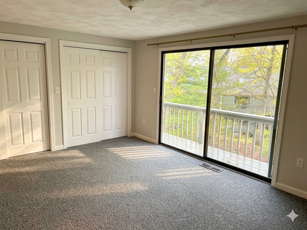 8 Deer Path, Unit 5 Maynard, MA 01754 - Photo 7 of 25 an empty room with windows