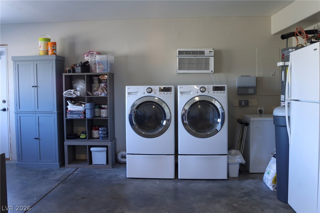 2775 Taylor Street Logandale, NV 89021 - Photo 28 of 41 This functional utility space features a modern washer and dryer setup.