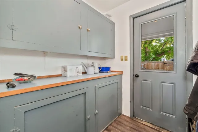 a utility room with cabinets washer and dryer