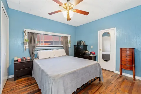 a bedroom with a bed and a chandelier