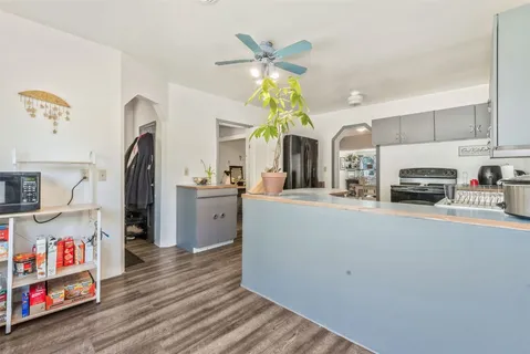 a living room with furniture and kitchen view