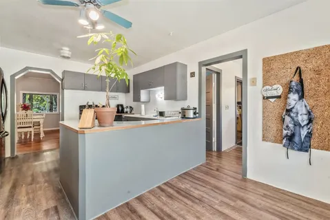 a living room with kitchen island furniture and a chandelier