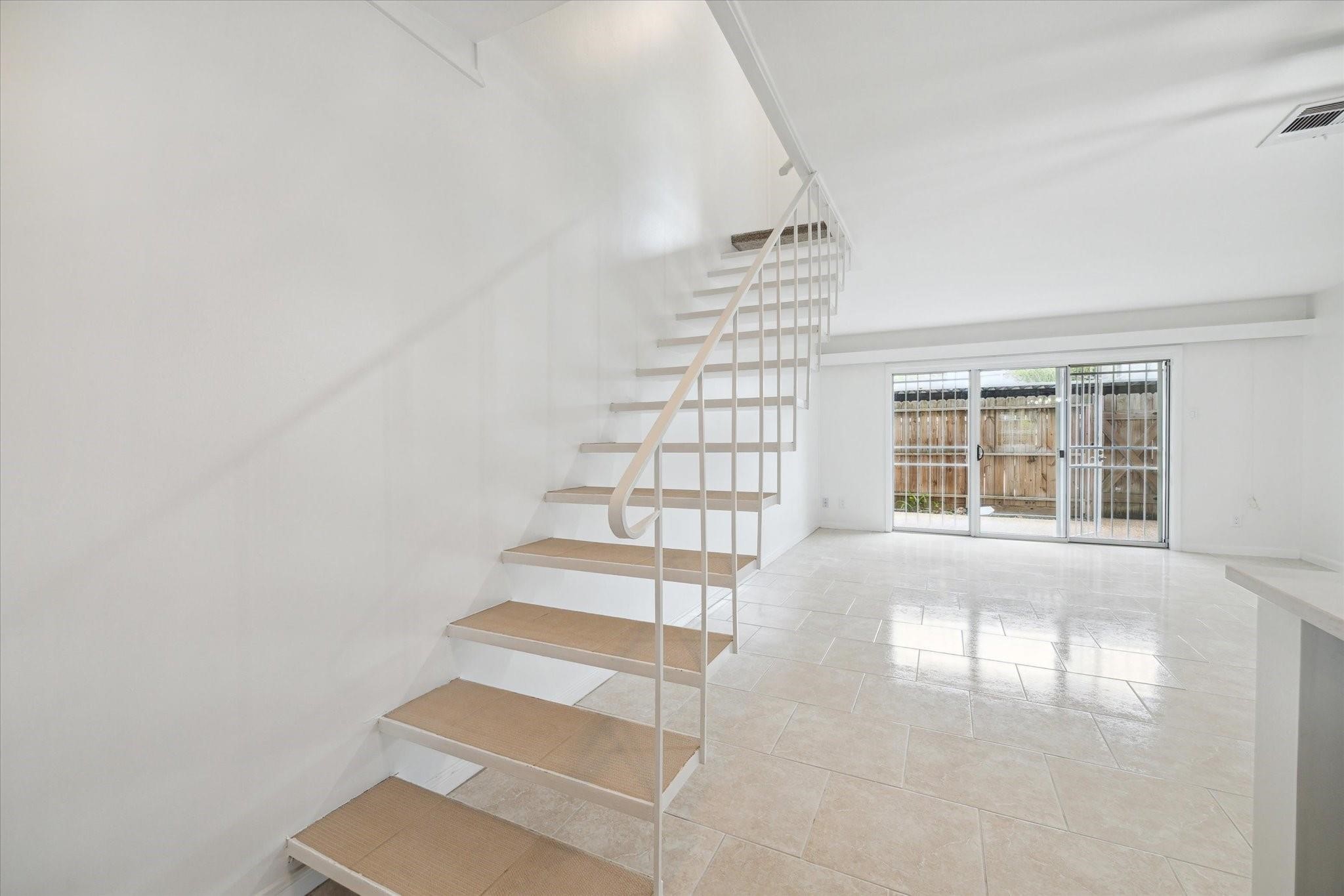 7821 Rue St Cyr Street, Unit 55 Houston, TX 77074 - Photo 6 of 16 Open staircase leading to the private second level.