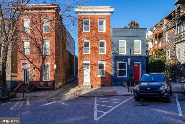 a view of a brick house with many windows