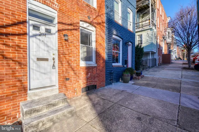 a pathway of a house with a yard