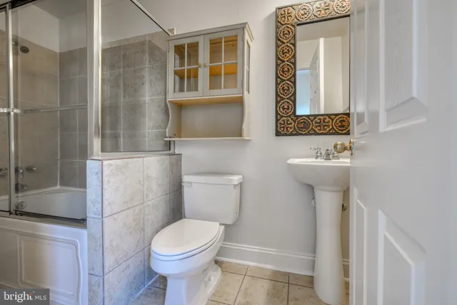 a bathroom with a sink mirror and toilet
