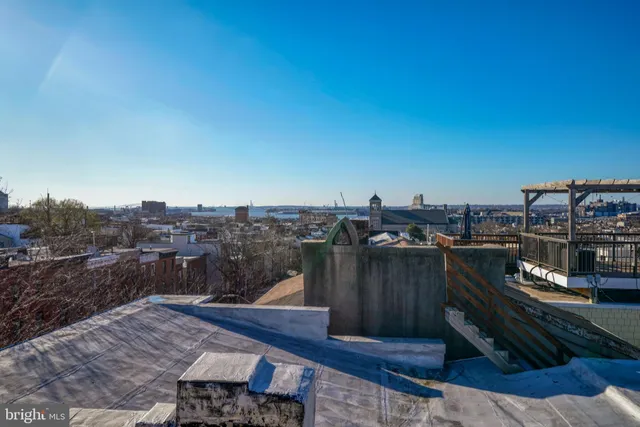 a view of a house with a wooden fence