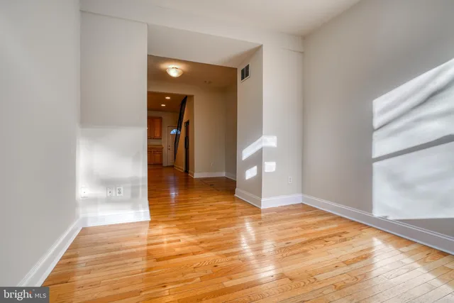 a view of a room with wooden floor and a sink