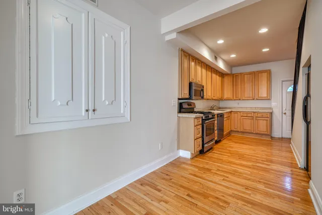 a view of a hallway with wooden floor