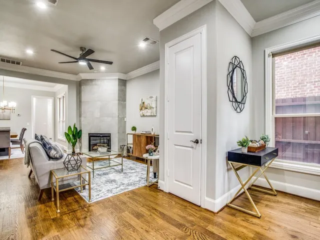 a living room with furniture a fireplace and a chandelier