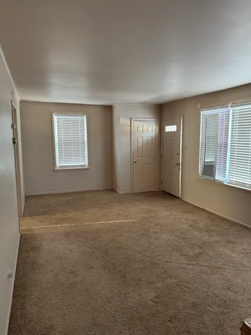 an empty room with a empty space and windows