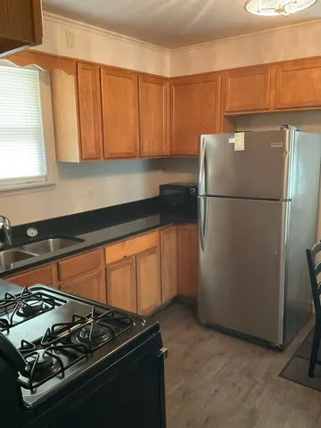 a kitchen with a refrigerator and a stove