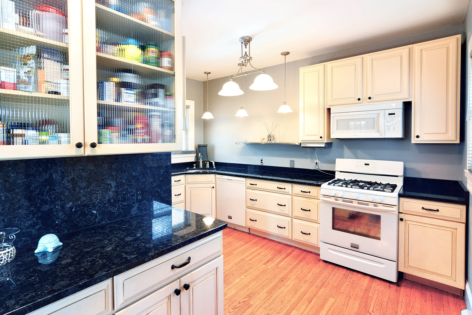 372 North Spring Street Elgin, IL 60120 - Photo 7 of 28 a kitchen with stainless steel appliances white cabinets and a granite counter tops