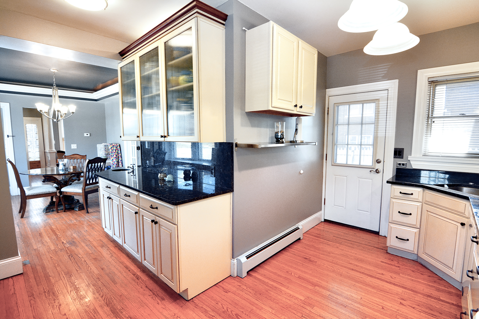 372 North Spring Street Elgin, IL 60120 - Photo 8 of 28 a kitchen with stainless steel appliances a stove a sink and white cabinets with wooden floor