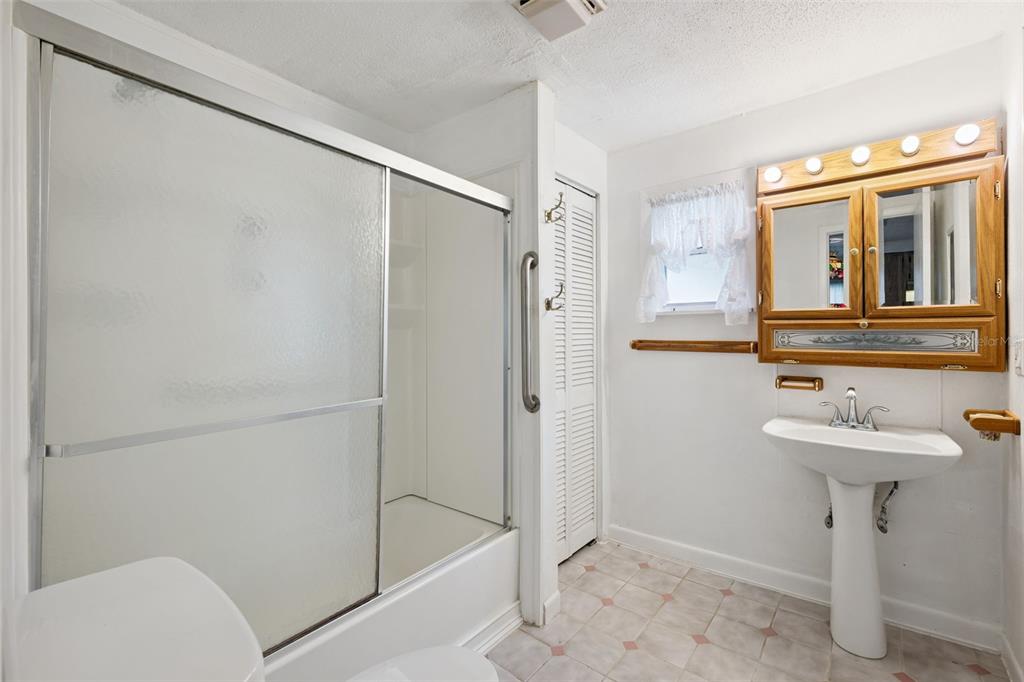 420 Jacks Memorial Road St. Cloud, FL 34769 - Photo 17 of 31 a bathroom with a sink toilet and shower